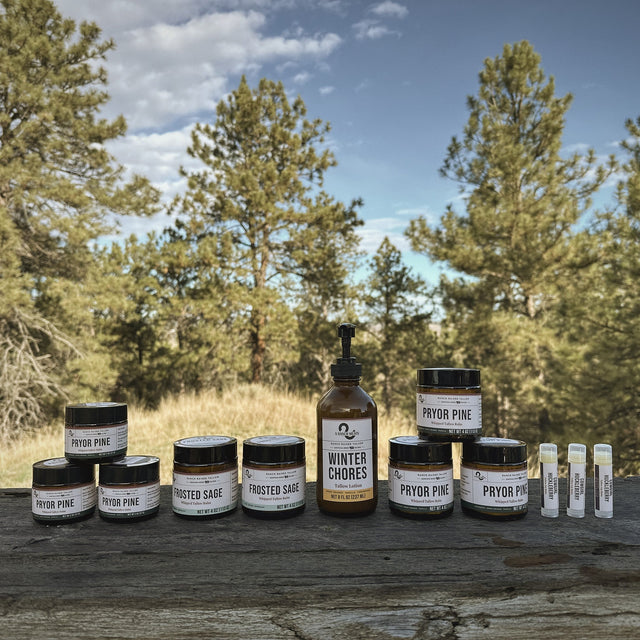 S Ranch Homeplace Holiday tallow collection on a ranch table under Montana pines