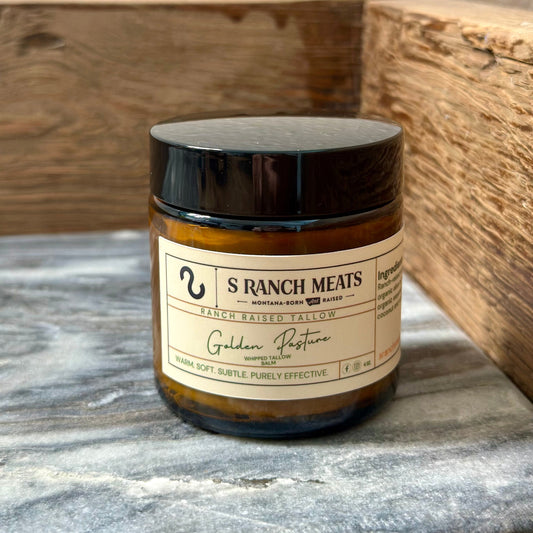 Jar of S Ranch Meats Golden Pasture whipped tallow balm, featuring a warm yellow label with elegant text, showcasing our natural, Montana-raised tallow skincare product.