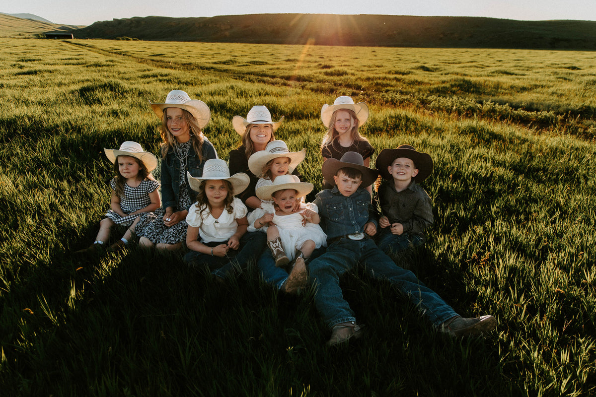 The Scott grandkids in the grass at the S Ranch