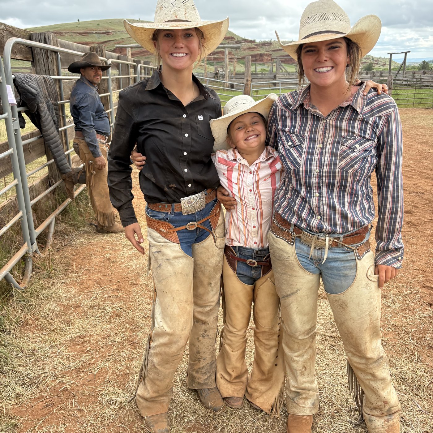 Three of the girls in their chaps at the branding pens