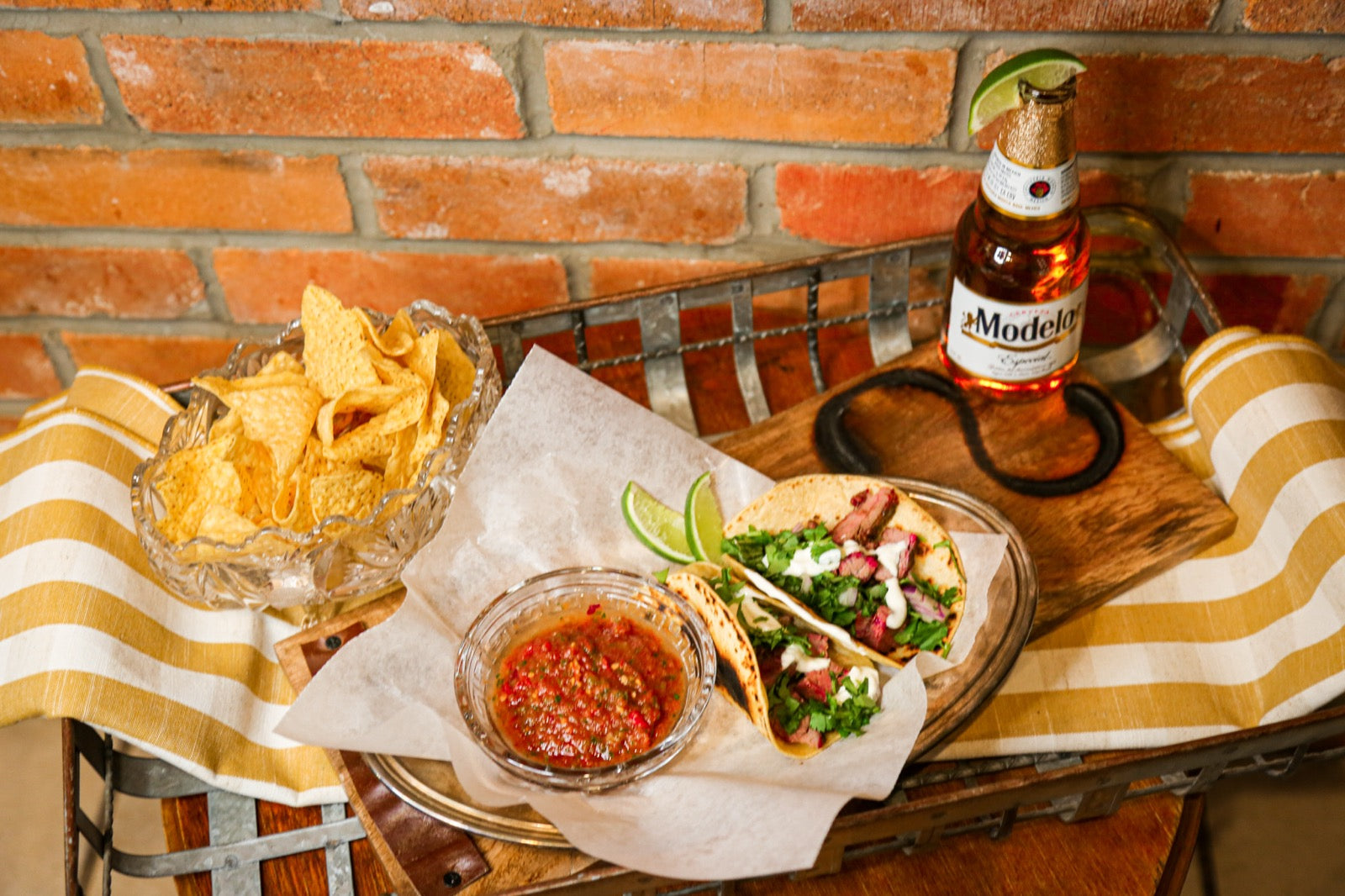 Skirt steak tacos with salsa, chips and lime